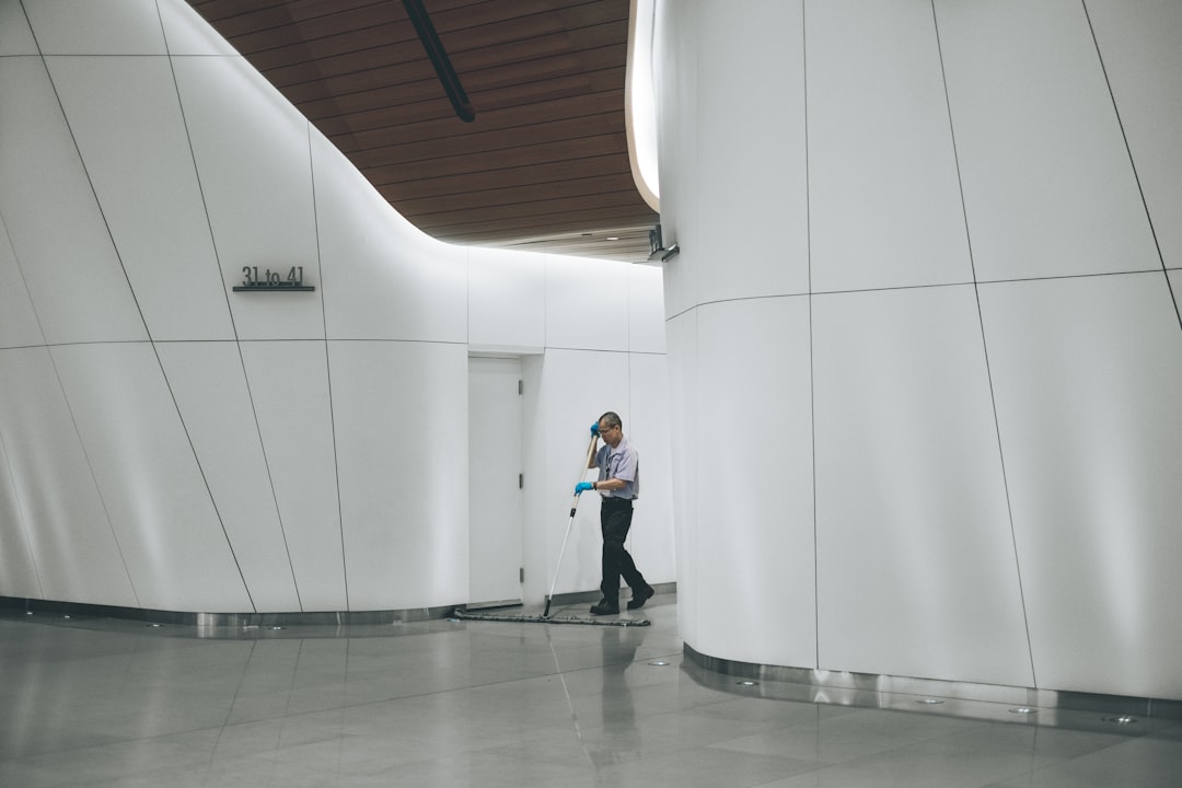 man-cleaning-on-floor-beside-white-wall-mww-zrkysiu